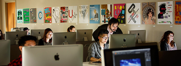 Professor helping a student in a computer lab